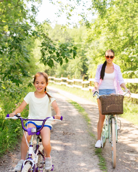 Mother and Daughter riding bikes on trail in Terrell, TX