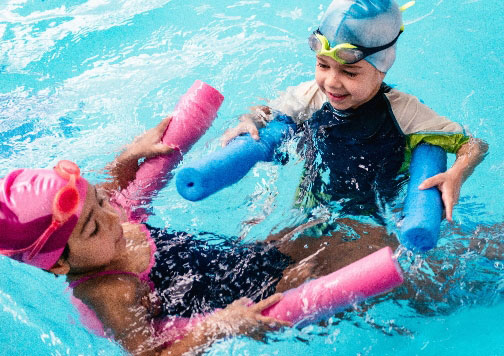 Two children playing in a swimming pool